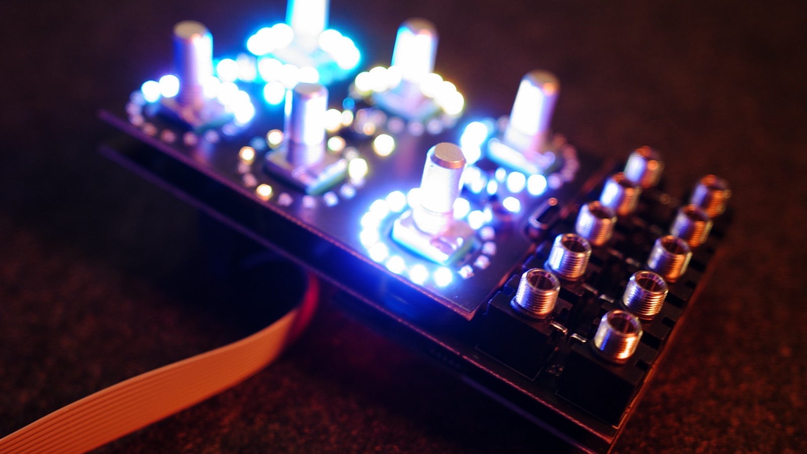 Alchemy Lab board running with all LED rings lit in blue and white, photographed without a faceplate
